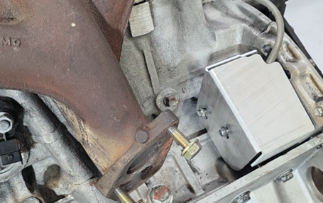 Aluminum CKPS shield installed over factory nuts