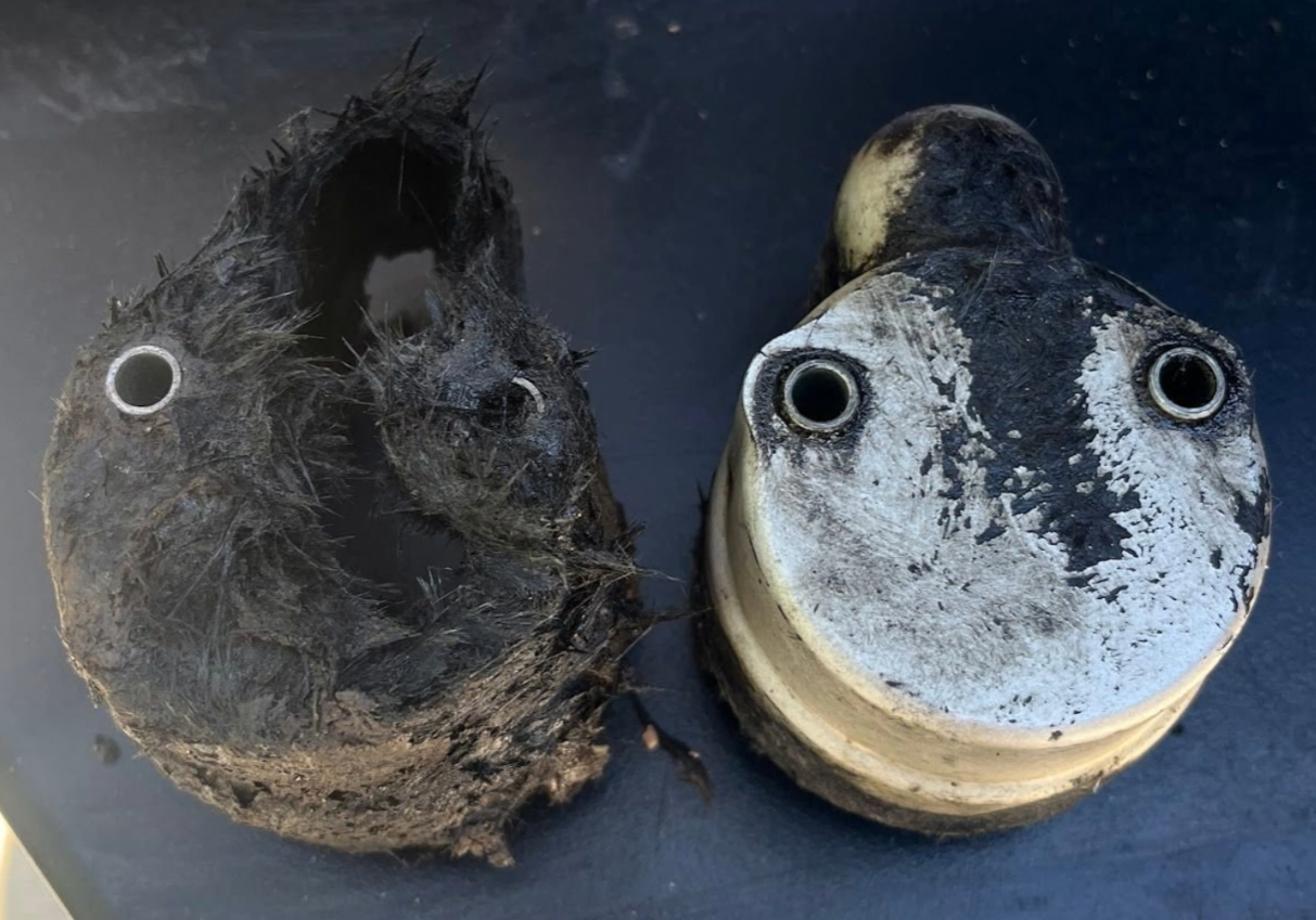 Degraded and crumbled fiberglass factory shield